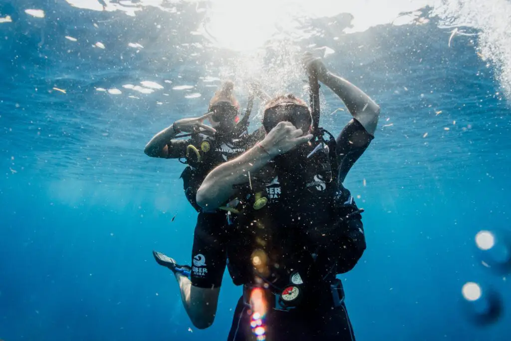 Divers equalizing during descent. - Photo by Uber Scuba Gili on Unsplash