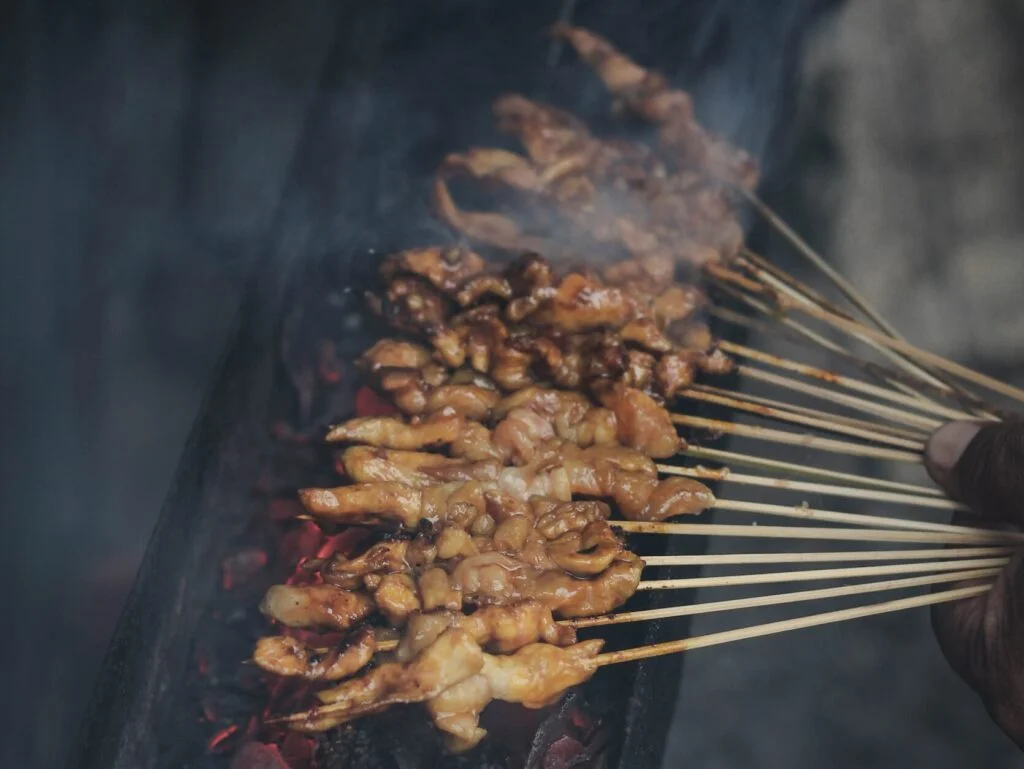 Satay, a Indonesian skewered meat, grilled and served with sauce - Photo By Akharis Ahmad on Unsplash