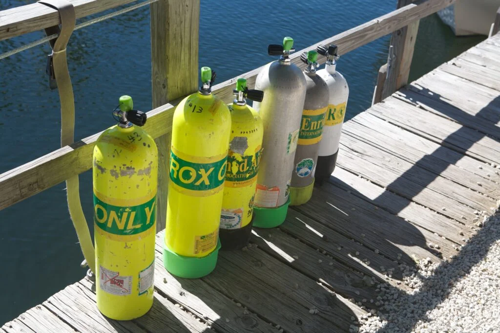 Nitrox tanks lined up, ready to get wet. - Photo by Andrew Snaps at Flickr