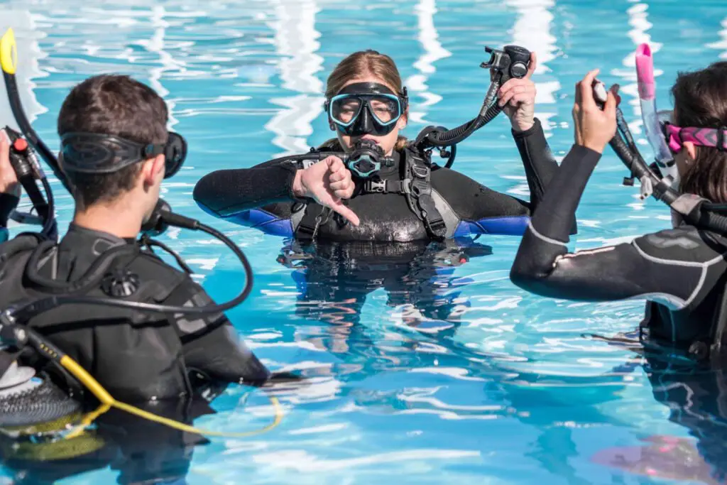 Scuba Dive Training In The Pool With An Instructor - Photo by Istock at Istock